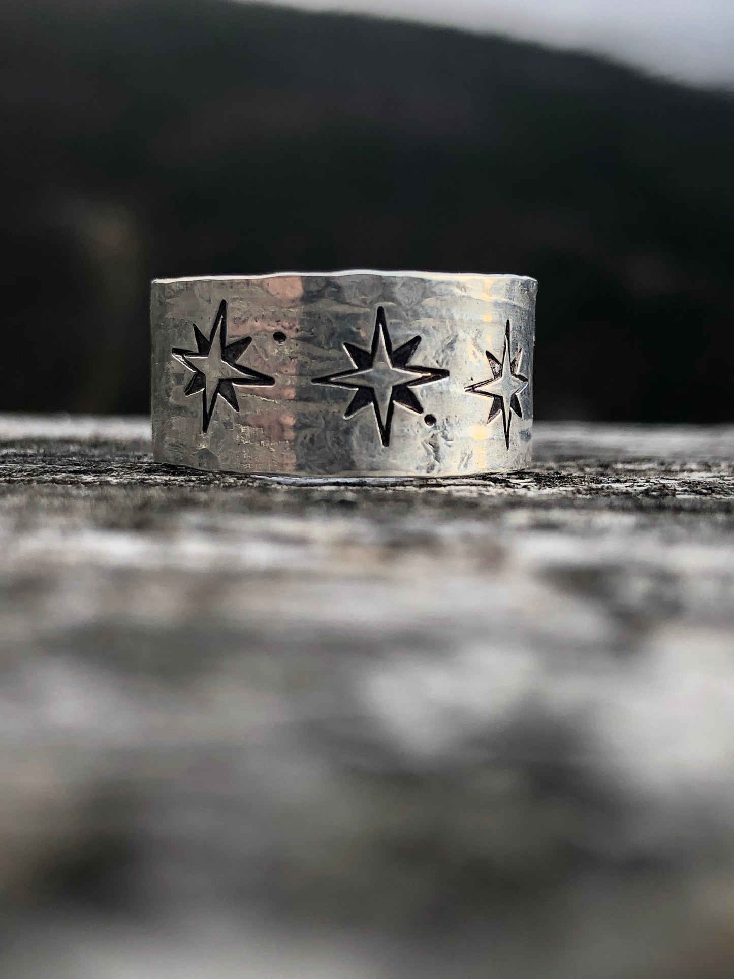 Sterling silver wide band compass rose north star ring with texture.