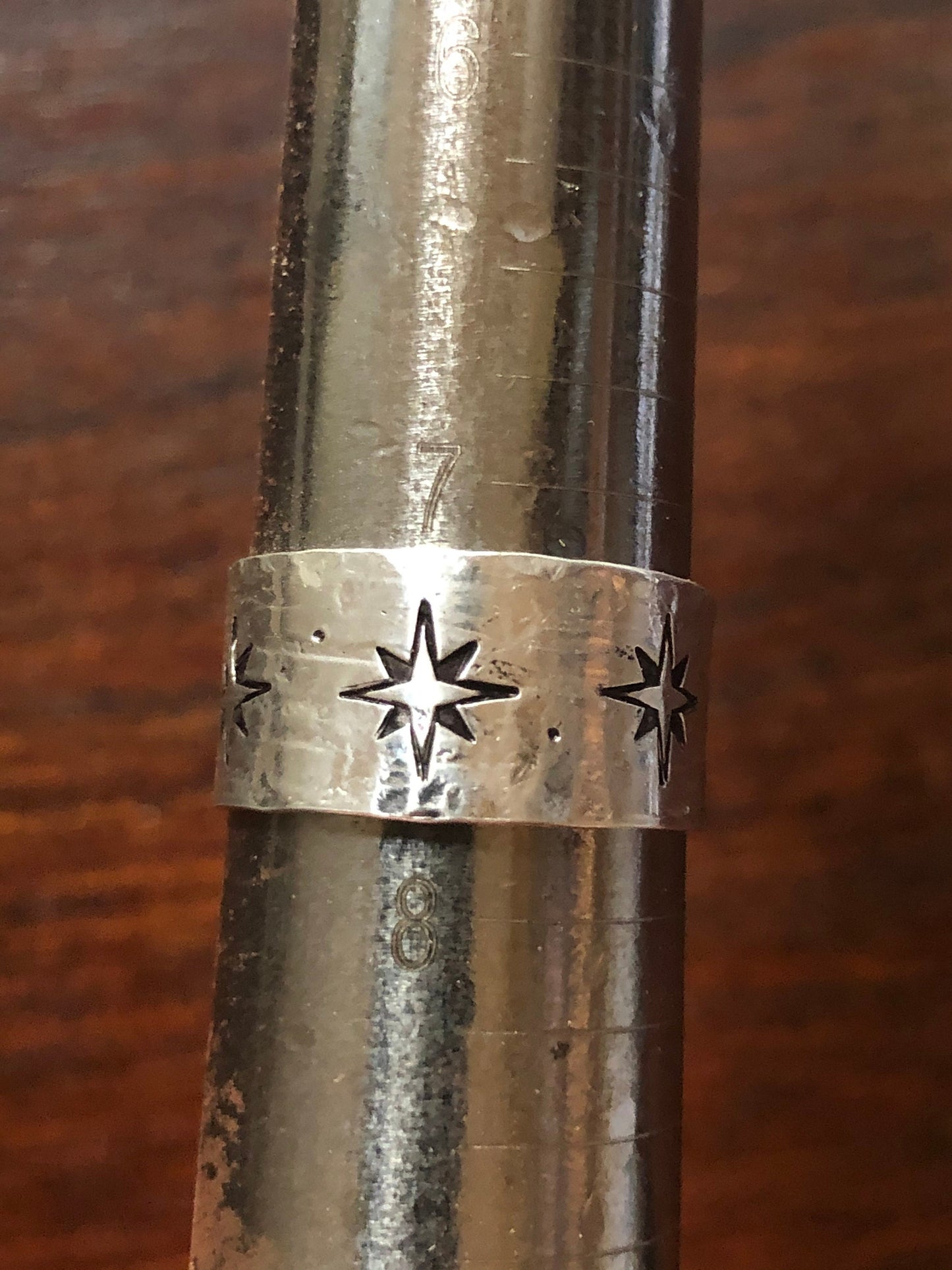 Sterling silver wide band compass rose north star ring with texture.