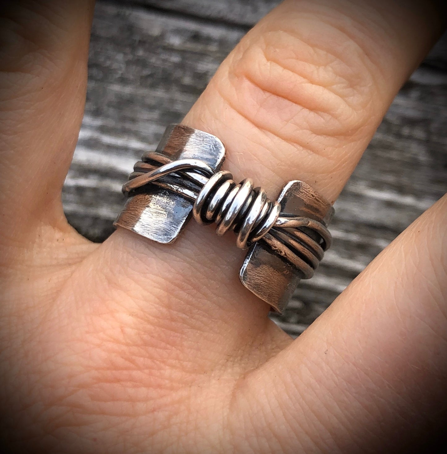 Hand made wide band sterling silver knot ring with open band.