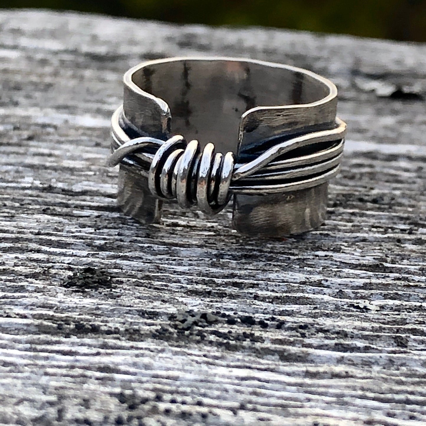 Hand made wide band sterling silver knot ring with open band.