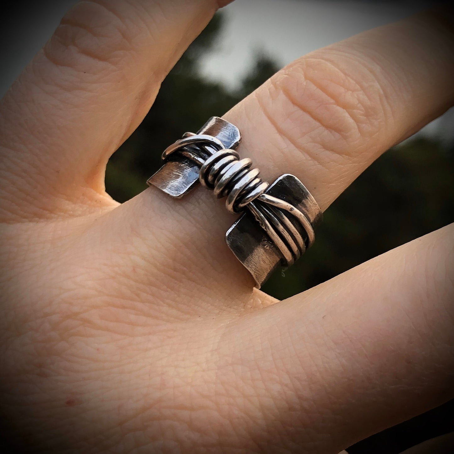 Hand made wide band sterling silver knot ring with open band.