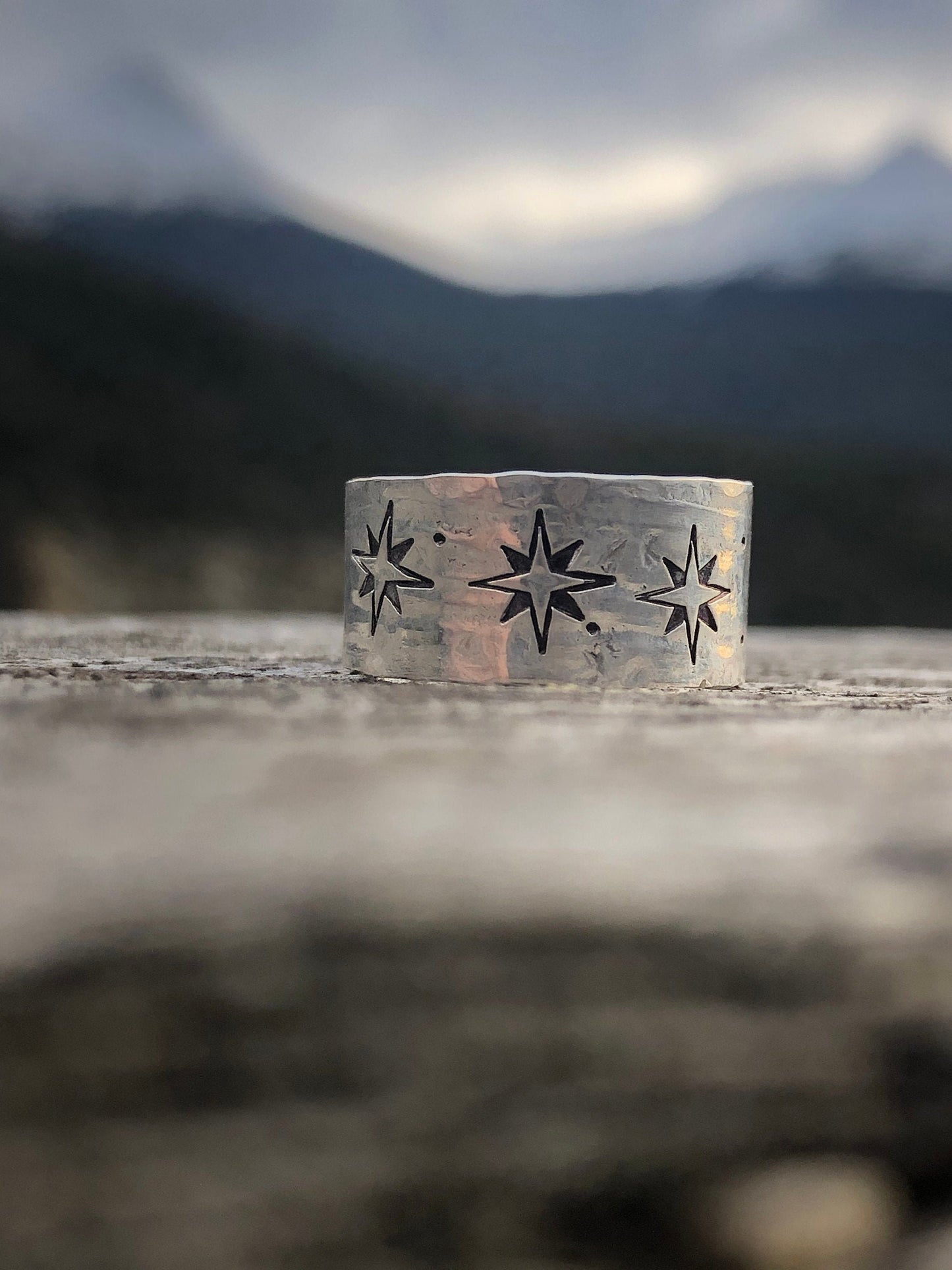 Sterling silver wide band compass rose north star ring with texture.