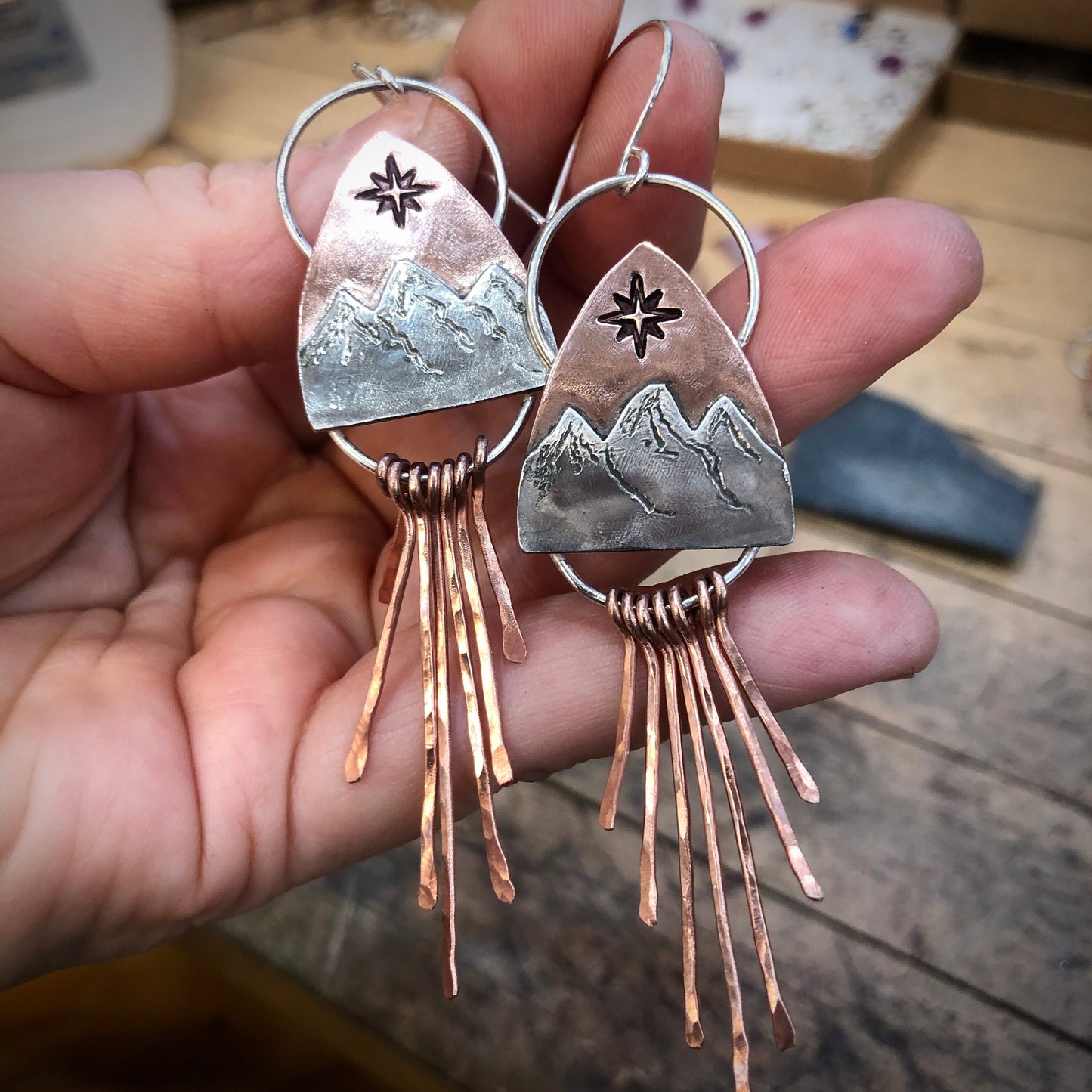 Copper and silver mountain earring with north star compass rose and fringe